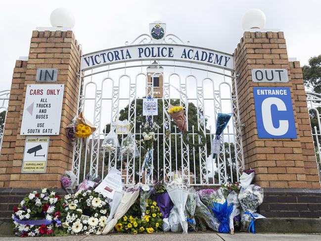 Floral tributes at the front gate of the Victoria Police Academy ahead of the funeral for the officers killed in the crash. Picture: Daniel Pockett