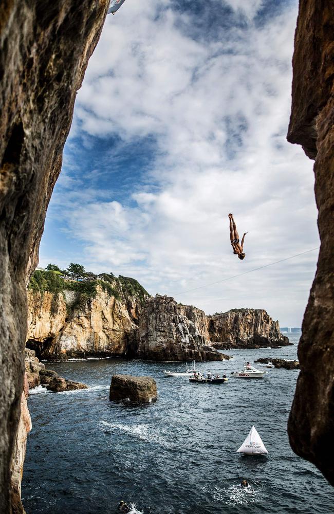 Gary Hunt of the UK diving from the 28 metre platform during the eighth stop of the Red Bull Cliff Diving World Series at Shirahama, Japan. Picture: AFP PHOTO / RED BULL / Dean TREML