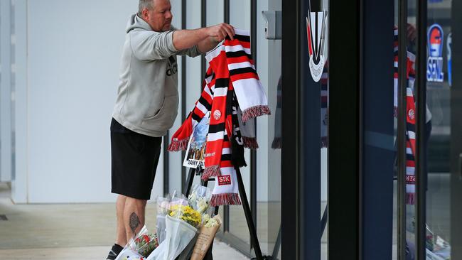 A fan adds to the tributes at Moorabbin. Picture: Mark Stewart