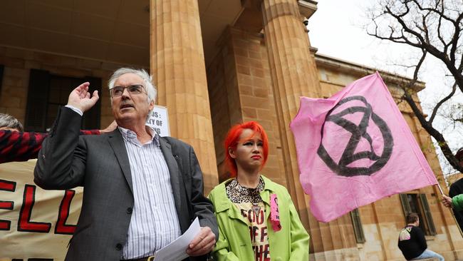 Extinction Rebellion members Mai Nguyen and Ian Fox (L) outside the Magistrates court. Picture NCA NewsWire / David Mariuz