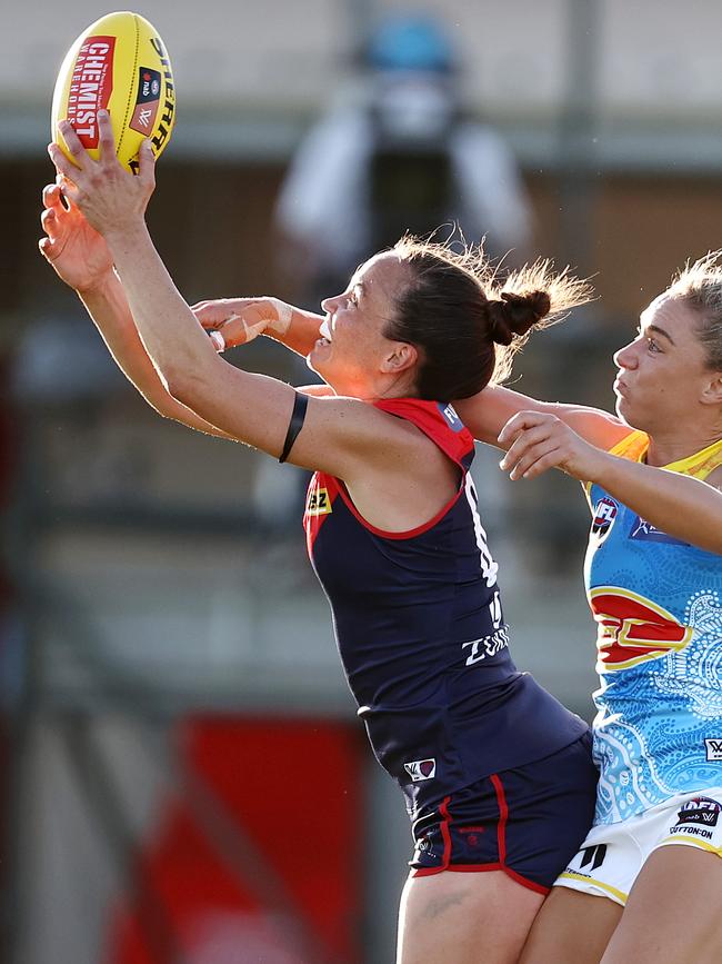 Demons star Daisy Pearce rises for a mark.