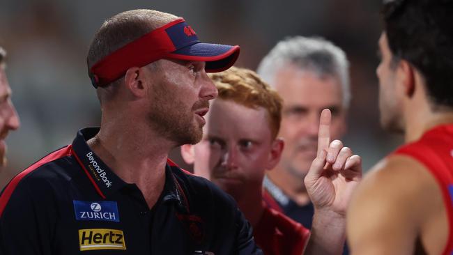 MELBOURNE, AUSTRALIA - FEBRUARY 28: Simon Goodwin, Senior Coach of the Demons speaks to the team during the 2024 AFL Community Series match between Carlton Blues and Melbourne Demons at Ikon Park on February 28, 2024 in Melbourne, Australia. (Photo by Daniel Pockett/Getty Images)