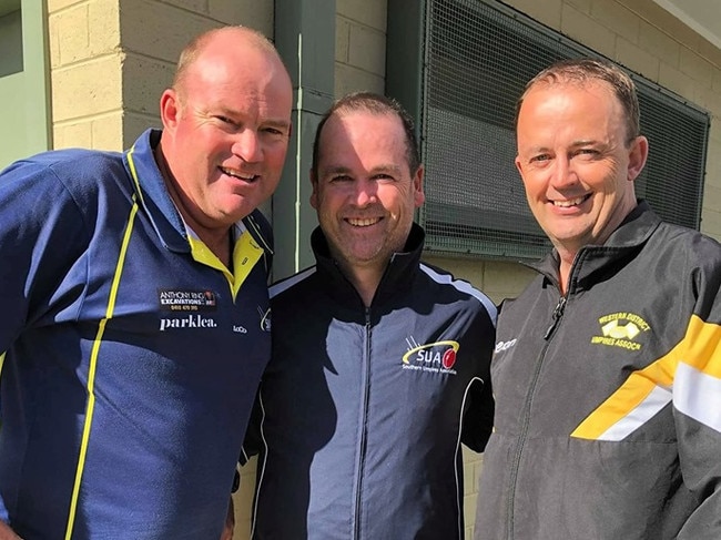 Jason Hughes (right) returned to the MPNFL to umpire his 500th game alongside Brett Gent (left) and Travis Dennerley.