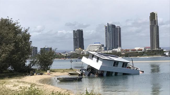 The half-submerged houseboat in the Broadwater near Sea World this morning.