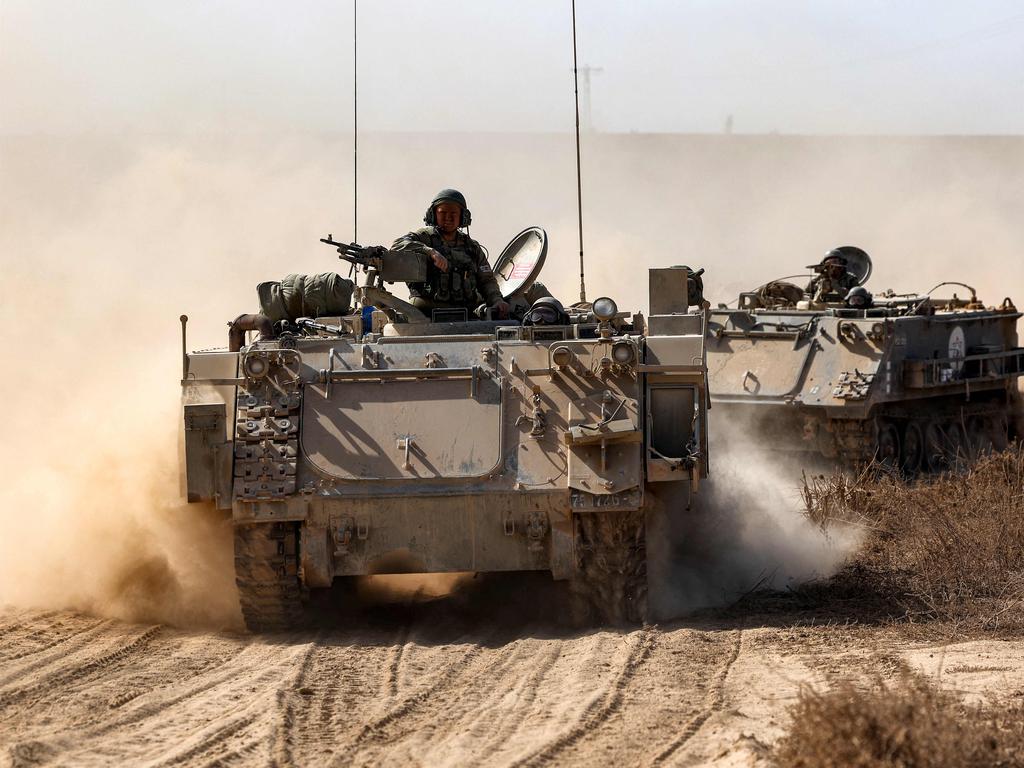 Israeli army infantry fighting vehicles deploy along the border with the Gaza Strip in southern Israel. Picture: AFP