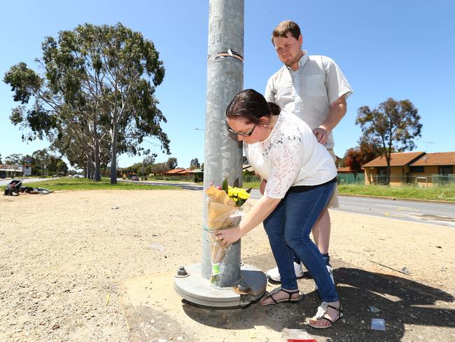 Sharna Wait and Rick Lidstone place flowers at the scene at Elizabeth South. Picture: Tait Schmaal schmaal.