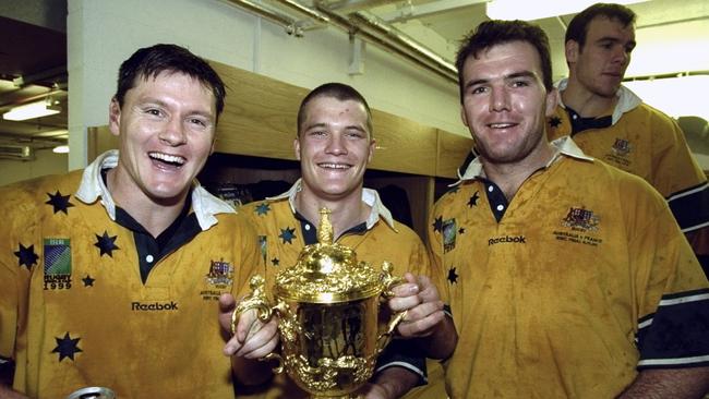 Wallabies (l-r) Matt Burke, Ben Tune and Owen Finegan with the Webb Ellis Cup after the 1999 Picture: Dave Rogers /Allsport