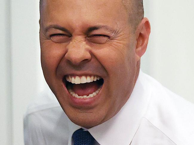 CANBERRA, AUSTRALIANewsWire Photos MARCH 29, 2022: The Treasurer Josh Frydenberg having a joke with the photographers about the flowers he received from two female cleaners who he has known for a long time,  on the morning of the 2022 Budget, at Parliament House in Canberra.Picture: NCA NewsWire / Gary Ramage