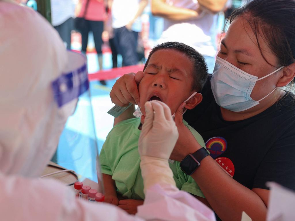 Covid-19 test on a child in Xiamen, in Fujian province in China, one of a handful of nations starting to vaccinate very young children. Picture: STR/AFP