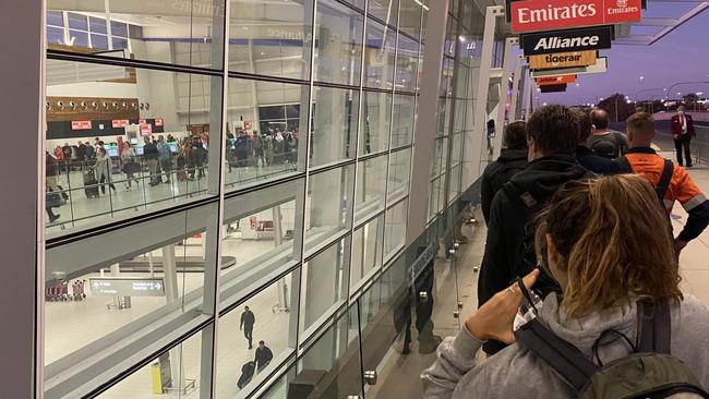 Adelaide Airport at 5.30am this morning. Lines for security at the airport are out the doors, around the barrier. Picture: Kathryn Bermingham