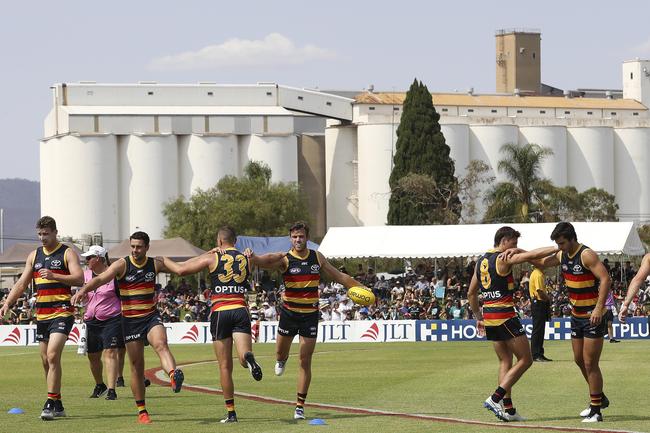 Crows players warm-up in front of the silos before the start of the game at Port Pirie. Picture SARAH REED