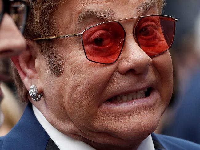 English singer-songwriter Elton John (R) and his husband Canadian producer David Furnish pose on the red carpet upon arriving for the UK premiere of the film Rocketman in London on May 20, 2019. (Photo by Adrian DENNIS / AFP)