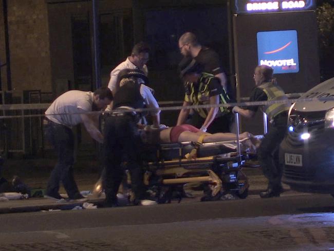 In this image made from PA Video footage, people receive medical attention in Thrale Street near London Bridge. Picture: PA via AP