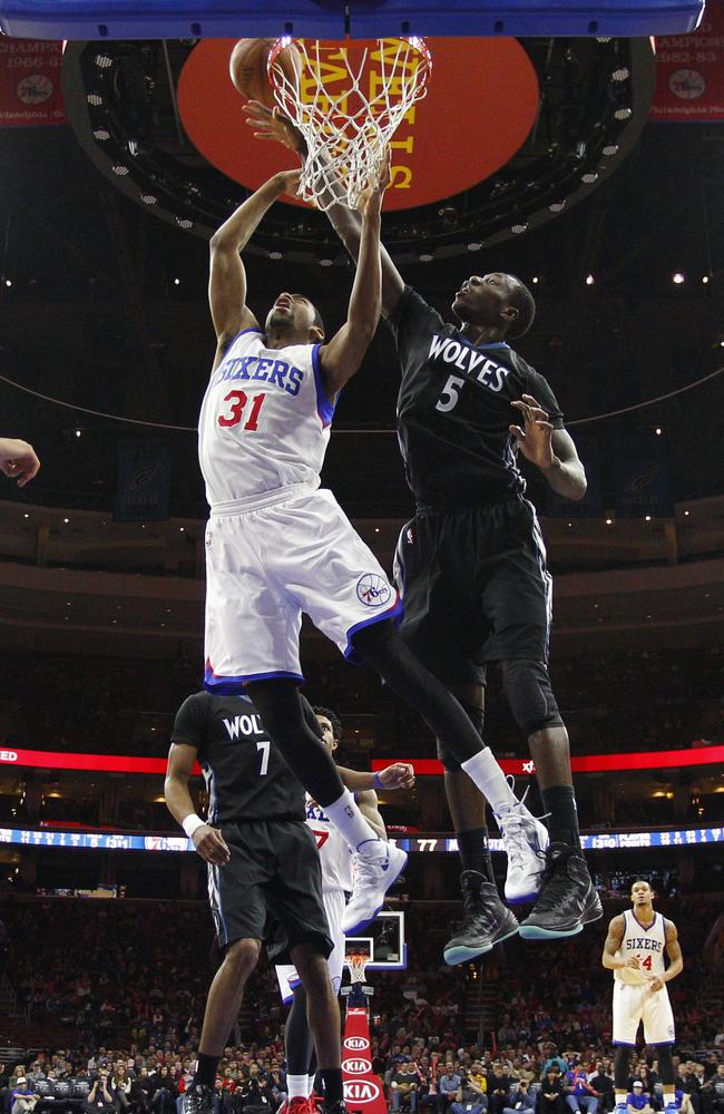 Minnesota Timberwolves' Gorgui Dieng (5) of Senegal knocks away the shot by Philadelphia 76ers' Hollis Thompson (31).