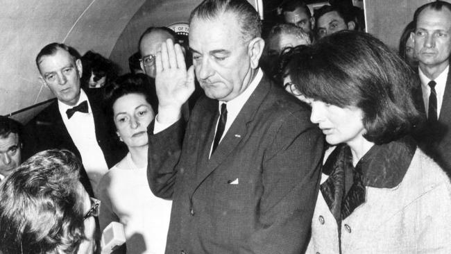 Lyndon Johnson swearing the oath of office on Air Force One, hours after Kennedy’s assassination.