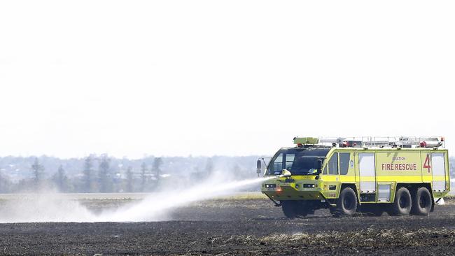 Aviation fire trucks were quickly on the scene to extinguishes spots still smouldering. Picture: NewsWire / John Appleyard