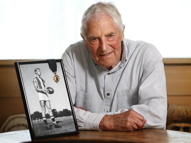 MELBOURNE . 29/03/2023.  AFL.  St Kilda legend Neil Roberts with a portrait of himself and his 1958 Brownlow Medal before the clubs 150th year anniversary this weekend.     . Pic: Michael Klein