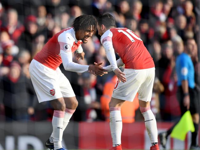 Alex Iwobi of Arsenal celebrates after scoring his team's third goal with Mesut Ozil of Arsenal during the Premier League match between Arsenal FC and Burnley FC. Picture: Getty Images