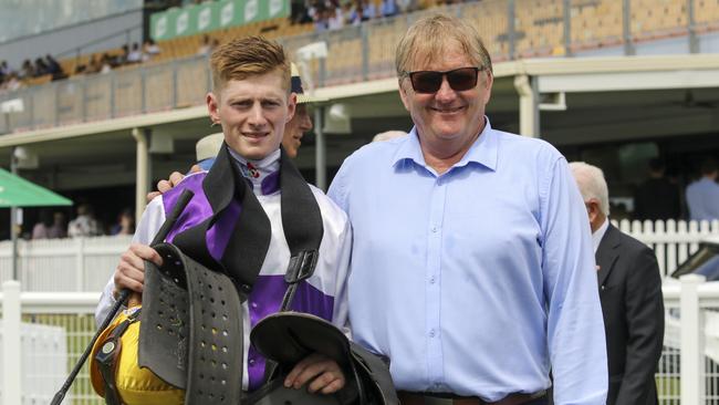 Kyle Wilson-Taylor alongside trainer Kelly Schweida after riding Slow Hands to victory at Doomben on March 26. Picture: Racing Queensland.