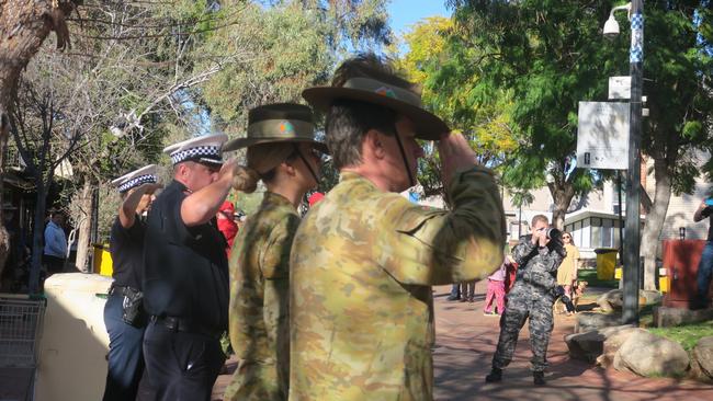 Soldiers and police salute the parade as it makes its way through the township. Picture: Laura Hooper.