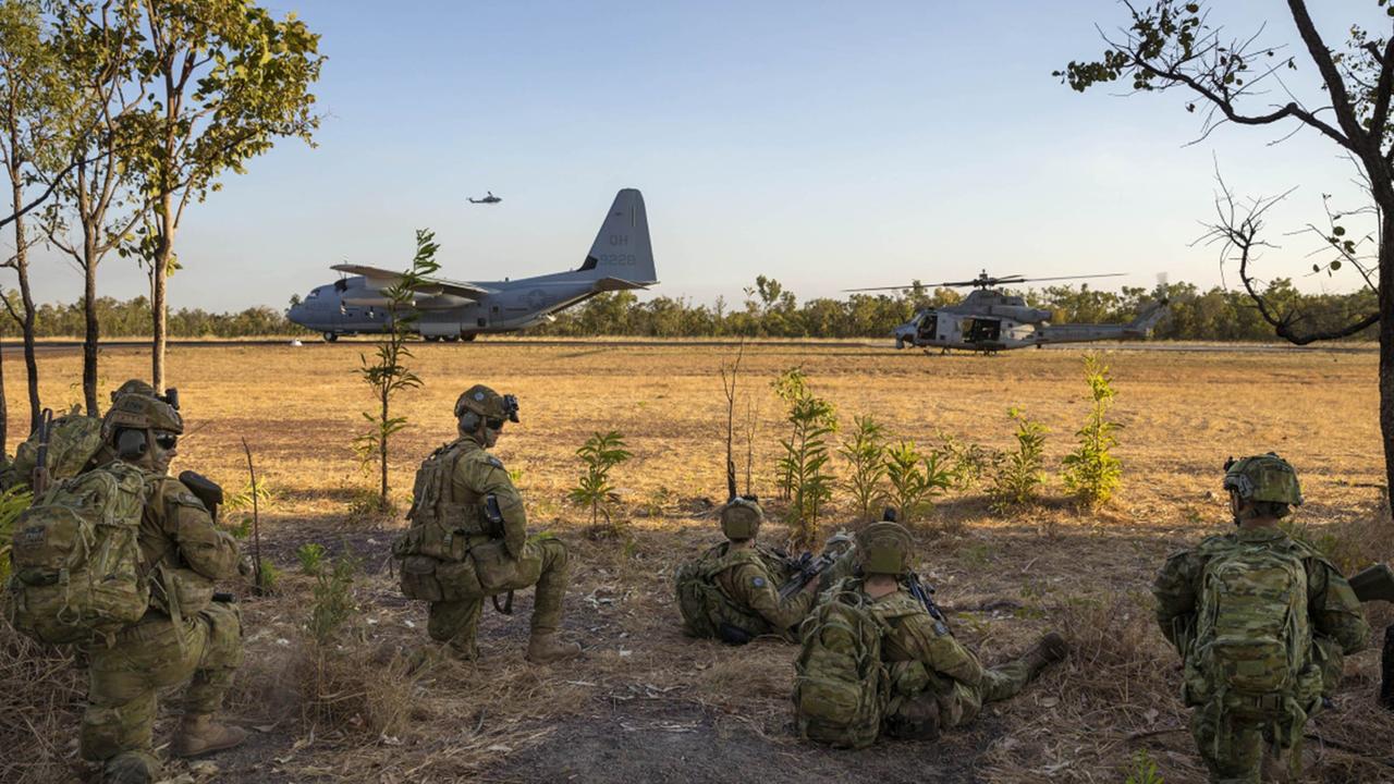 Soldiers from the 5th Battalion, the Royal Australian Regiment watch on as United States Marine Corps C-130 Hercules, AH-1W Super Cobra and UH-1Y Venom aircraft prepare to depart the airstrip at Mount Bundey Training Area in the Northern Territory as part of Exercise Talisman Sabre. Picture: Defence