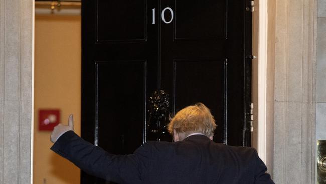 British Prime Minister Boris Johnson heads back into 10 Downing Street on Wednesday after the parliament backed an early election. Picture: AP