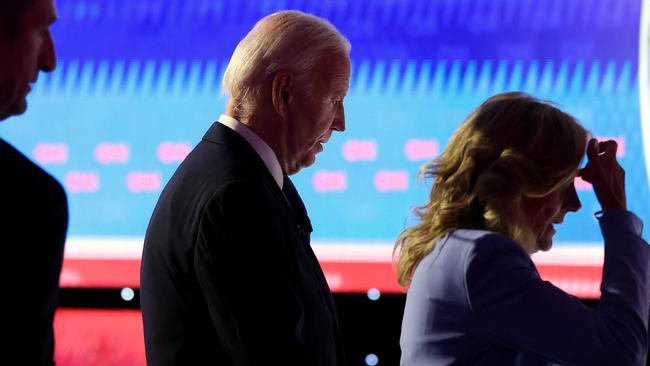 President Joe Biden walks off with first lady Jill Biden following the CNN Presidential Debate in Atlanta.