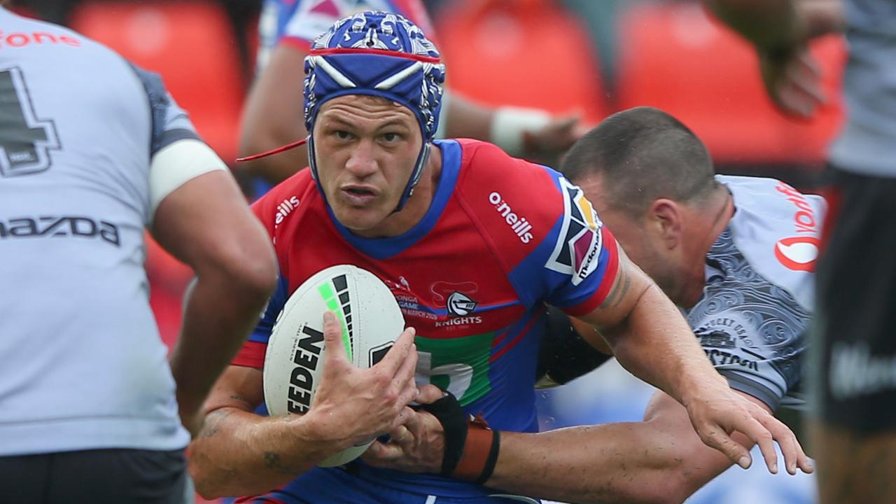 Kalyn Ponga of the Newcastle Knights is tackled by the Warriors.