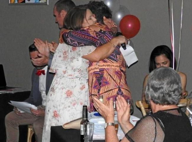 Gabe Watkin receiving her life membership to the Yeppoon Swans from close friend Rachel Boyd. Picture: Shayla Bulloch