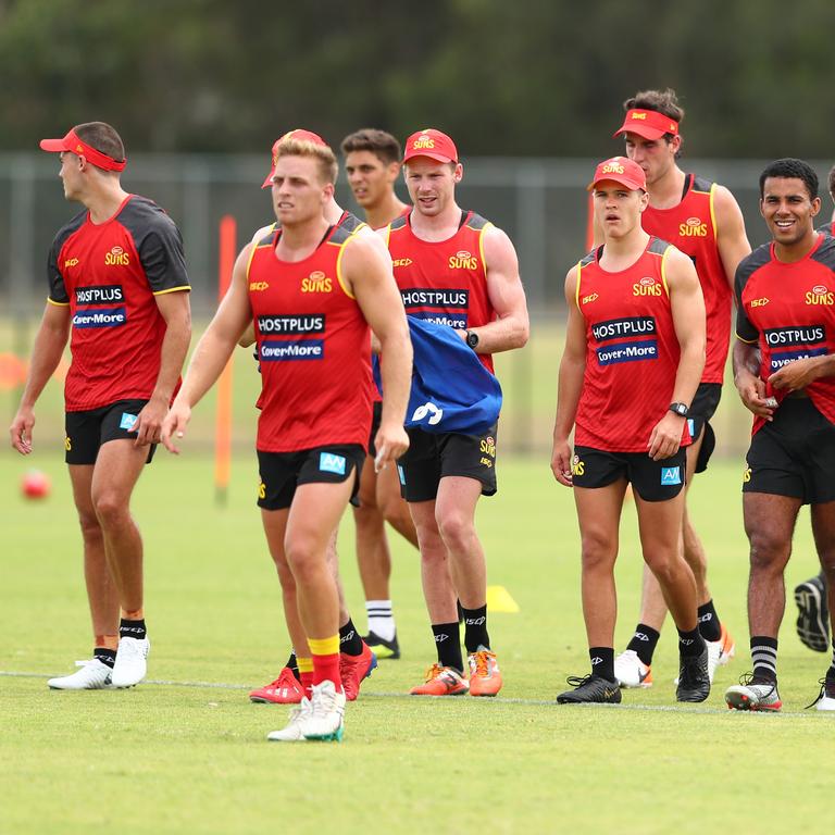 Players talk during a Gold Coast Suns AFL media and training session at Metricon Stadium. (Photo by Chris Hyde/Getty Images)