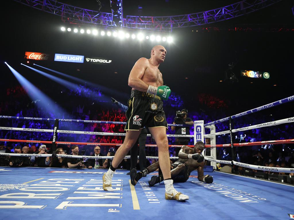 Tyson Fury knocks down Deontay Wilder in the fifth round. (Photo by Al Bello/Getty Images)