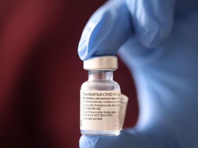 CHICAGO, ILLINOIS - DECEMBER 17: A nurse shows a container of Pfizer-BioNTech COVID-19 vaccine after it was used to vaccinate the first five staff members at Roseland Community Hospital on December 17, 2020 in Chicago, Illinois. Roseland Community Hospital is situated in the Roseland neighborhood on the city's far south side. The neighborhood's population is 95 percent black. The COVID-19 death rate among black residents in Chicago is nearly double that of the cityâs white residents.   Scott Olson/Getty Images/AFP == FOR NEWSPAPERS, INTERNET, TELCOS & TELEVISION USE ONLY ==