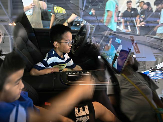 Children are seen inside a Xiaomi SU7 electric vehicle on display during the World Intelligence Expo in Tianjin in June. Picture: AFP