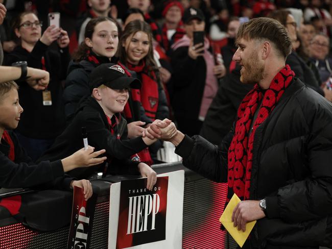 MELBOURNE, AUSTRALIA - AUGUST 16: Dyson Heppell of the Bombers greets fans during the round 23 AFL match between Essendon Bombers and Sydney Swans at Marvel Stadium, on August 16, 2024, in Melbourne, Australia. (Photo by Daniel Pockett/Getty Images)