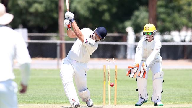 Jordan Wood (Pulteney OS) is bowled by Simon Hatji. A1 Turf Cricket. Brighton v Pulteney OS, at Brighton Oval. Picture: Stephen Laffer