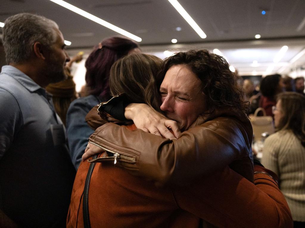 Women embrace after the results are announced. (Photo by Megan JELINGER / AFP)