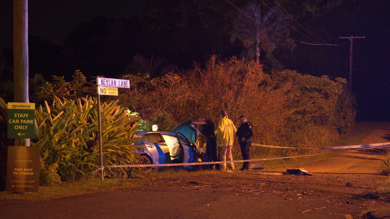 Police inspect the scene where a blue Toyota Corolla crashed into a white Suzuki Swift in Woombye.