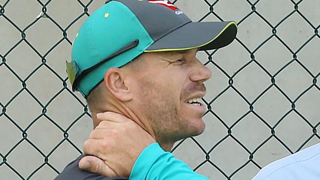 David Warner holds onto his neck at an Australian Cricket team training session at the Gabba, in Brisbane, Tuesday, November 21, 2017. Australia will take on England on Thursday in the first Test of the Ashes series at the Gabba in Brisbane. (AAP Image/Jono Searle) NO ARCHIVING