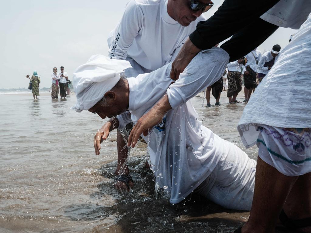 A Balinese Hindu in trance during Melasti, a pre-Nyepi purification ritual, at Petitenget Beach in Bali. Picture: Yasuyoshi Chiba/AFP