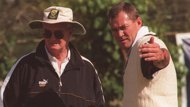 Mallett helps out South Africa spinner Pat Symcox in 1997.