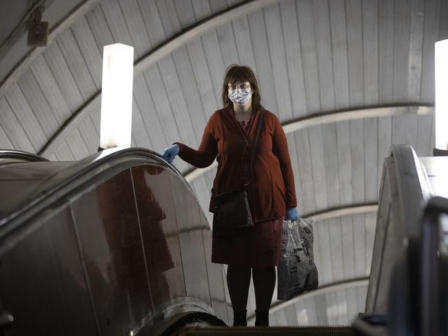 A woman wearing mask and gloves in a Moscow subway. Picture: AP