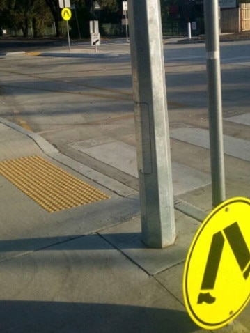 A street sign nailed to the lower end of the pole, meaning less eyes would see it. 