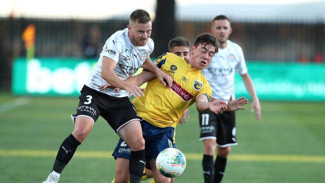 Lewis Miller of the Central Coast Mariners contests the ball with Scott Jamieson of Melbourne City during their round 24 A-League match.