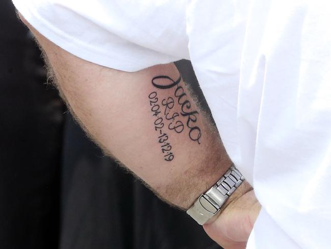 Father Brett Beasley now has a fresh tattoo on his left arm. Picture: AAP Image/Richard Gosling