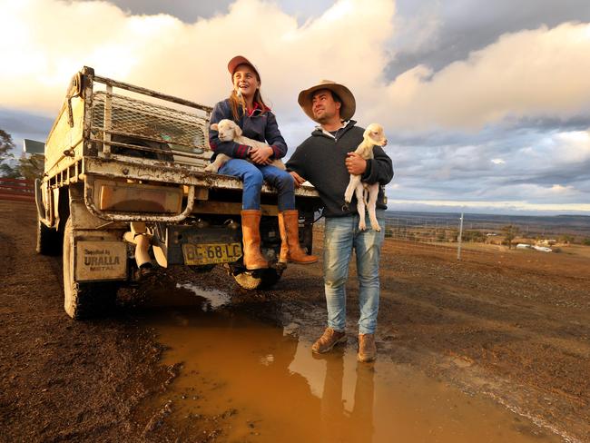 Farmer Jock McLaren with his 11-year-old daughter Mimi welcomed rain on their drought stricken property between Walcha and Tamworth earlier this month. Picture: Nathan Edwards