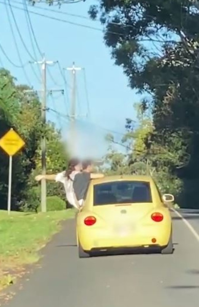 People seen hanging out of their car window. Picture: Queensland Police