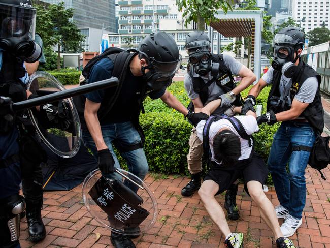 Police arrest a man during violent clashes with protesters in Hong Kong. Picture: AFP.