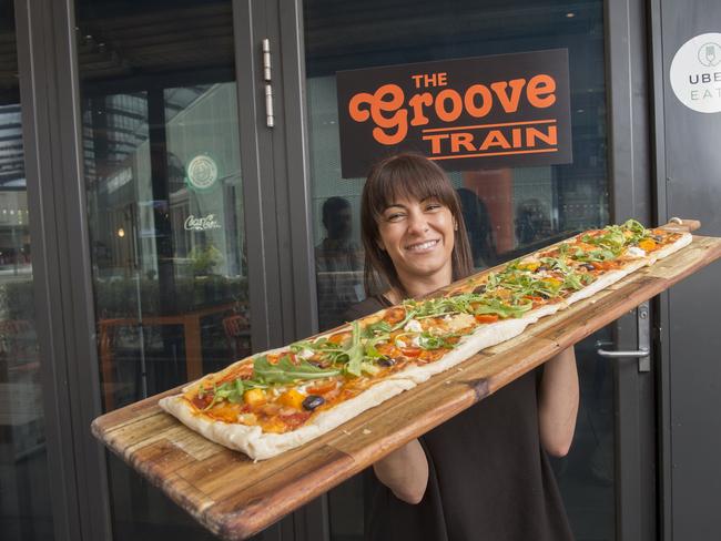 Melanie Cutajar at the Groove Train in Epping with one of the new metre long pizzas. Picture: Rob Leeson.