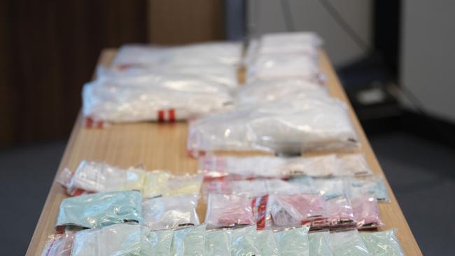 (Front): Drugs seized last December in Hobart. (Back): $5.5m of cocaine and meth allegedly found in Baldwin’s checked luggage at Hobart Airport. Picture: Chris Kidd