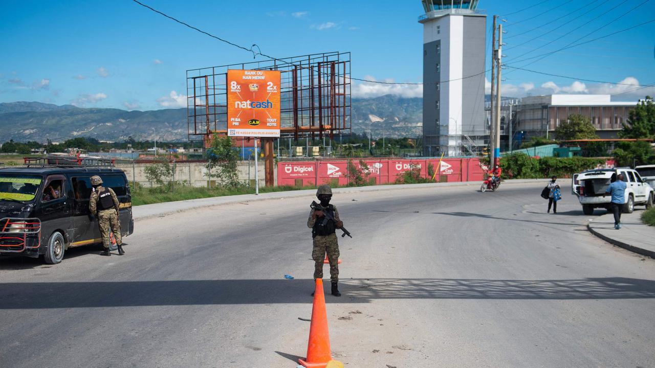 Police officers patrol near the Toussaint Louverture International Airport in Port-au-Prince, Haiti. Picture: Clarens SIFFROY / AFP.